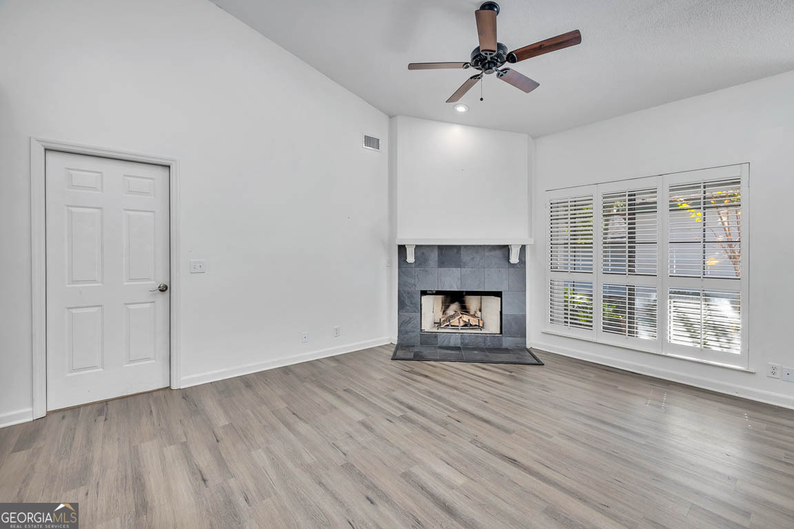 3 Bay Tree Court West St. Simons, GA 31522 - Photo 24 of 36 a view of an empty room with wooden floor fireplace and a window