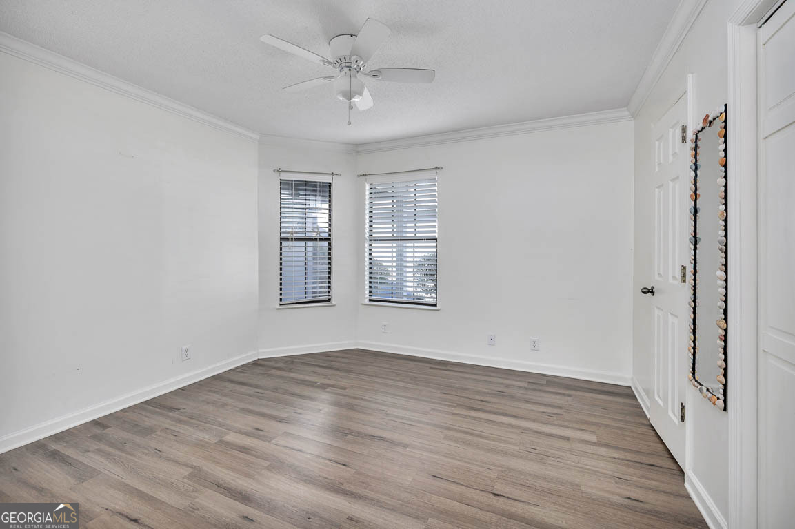 3 Bay Tree Court West St. Simons, GA 31522 - Photo 27 of 36 a view of an empty room with wooden floor and a window