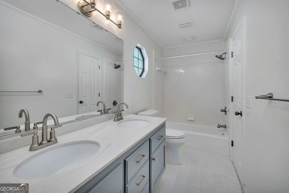 3 Bay Tree Court West St. Simons, GA 31522 - Photo 28 of 36 a bathroom with a sink a toilet and shower