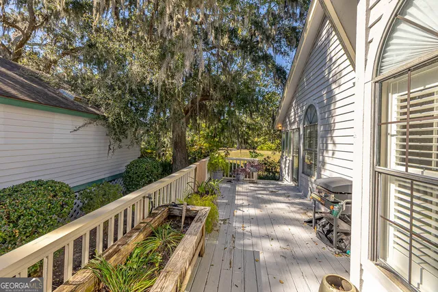 a view of a house with wooden floor next to a yard