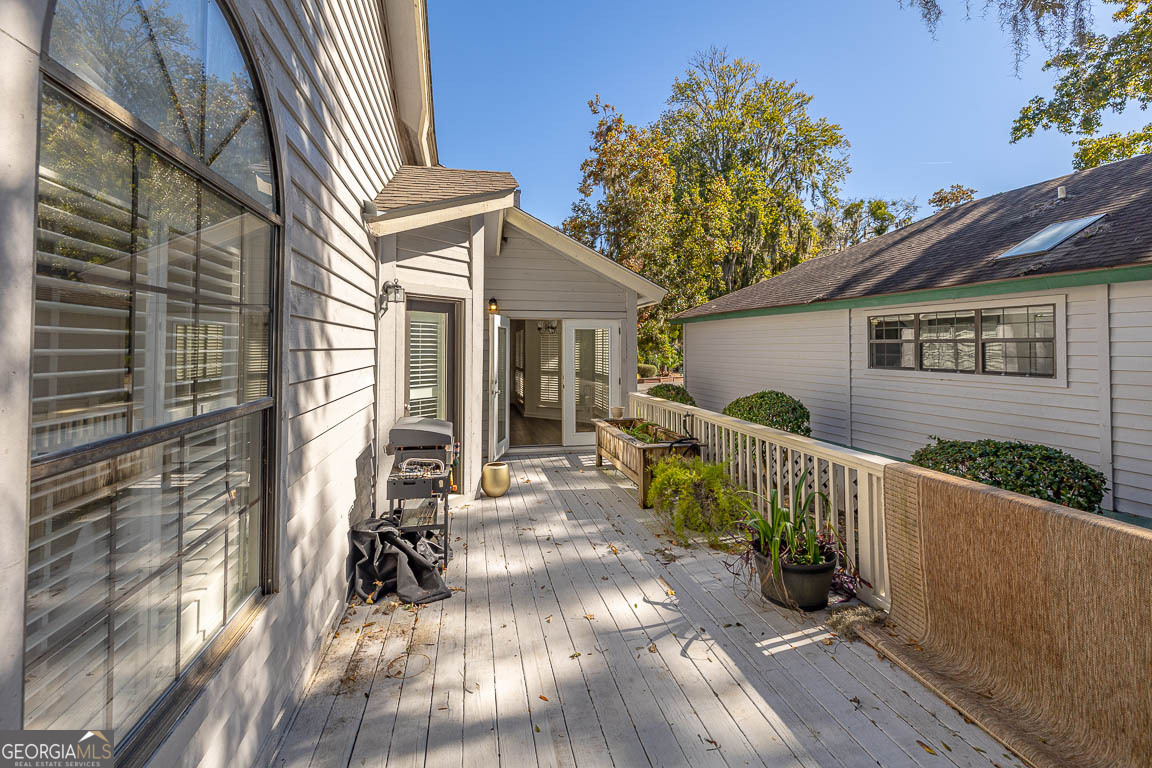 3 Bay Tree Court West St. Simons, GA 31522 - Photo 33 of 36 a view of a house with wooden floor next to a yard