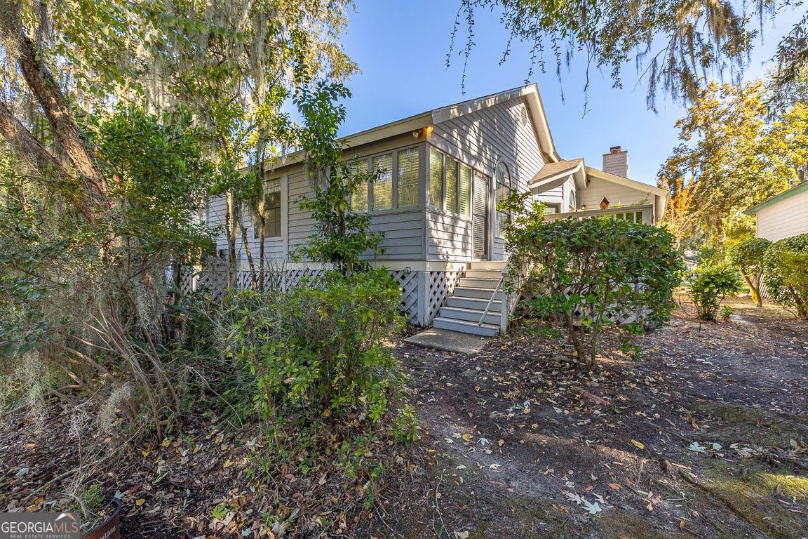 3 Bay Tree Court West St. Simons, GA 31522 - Photo 36 of 36 a view of a house with backyard and garden