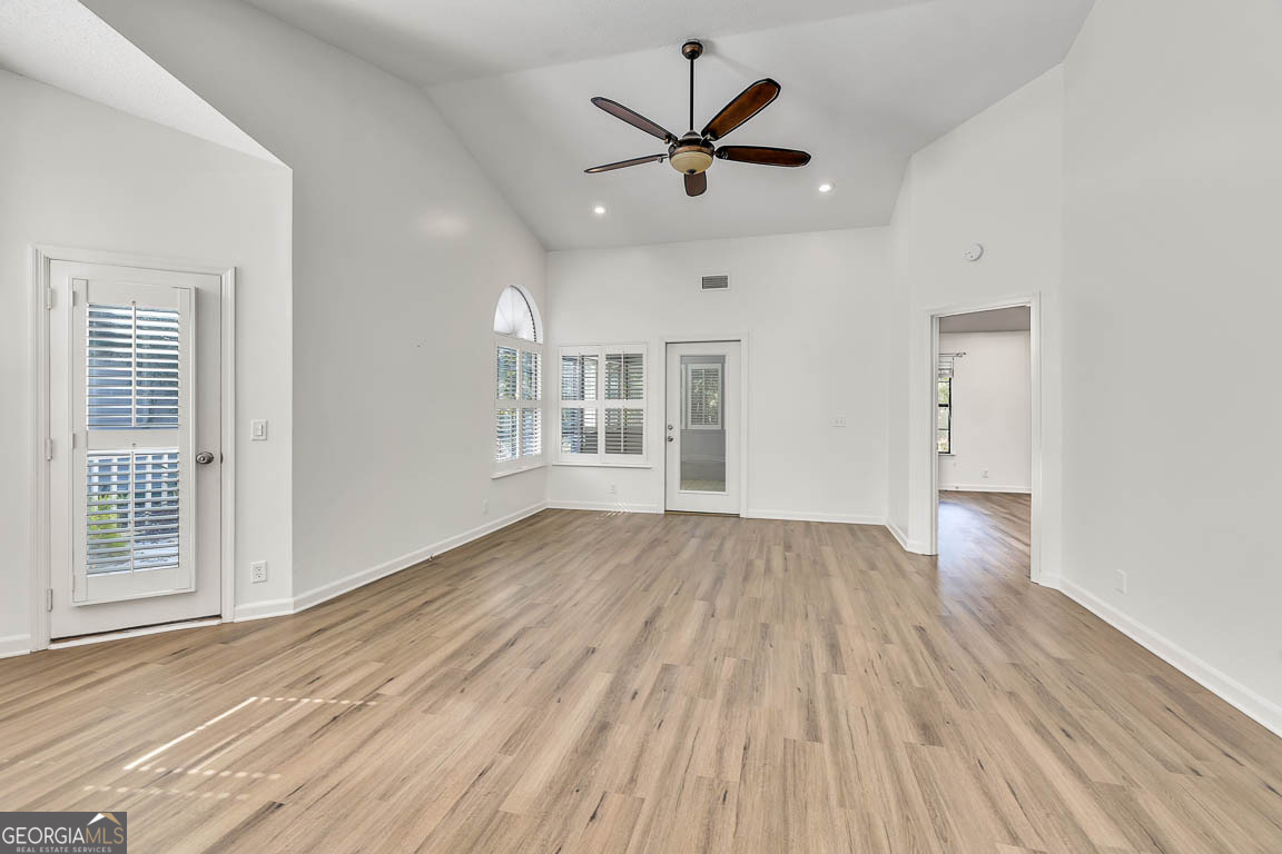 3 Bay Tree Court West St. Simons, GA 31522 - Photo 7 of 36 wooden floor in an empty room with a window