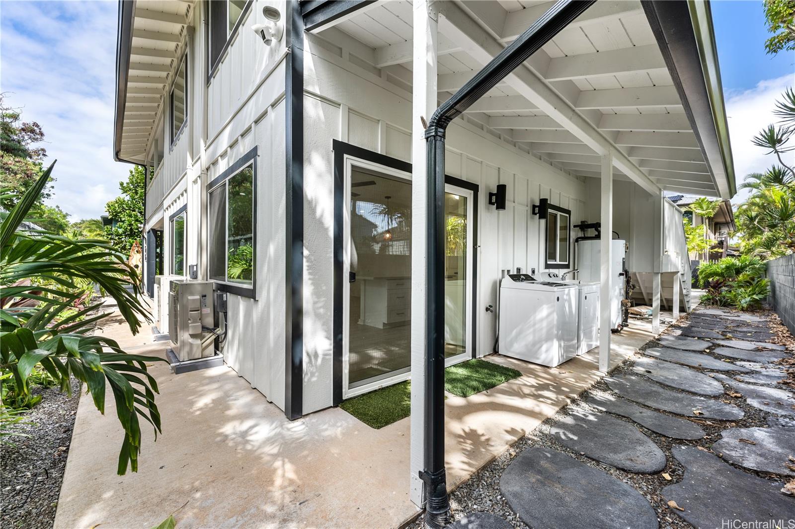 437 Kawailoa Road Kailua, HI 96734 - Photo 14 of 16 a view of a patio with table and chairs potted plants with wooden floor and fence