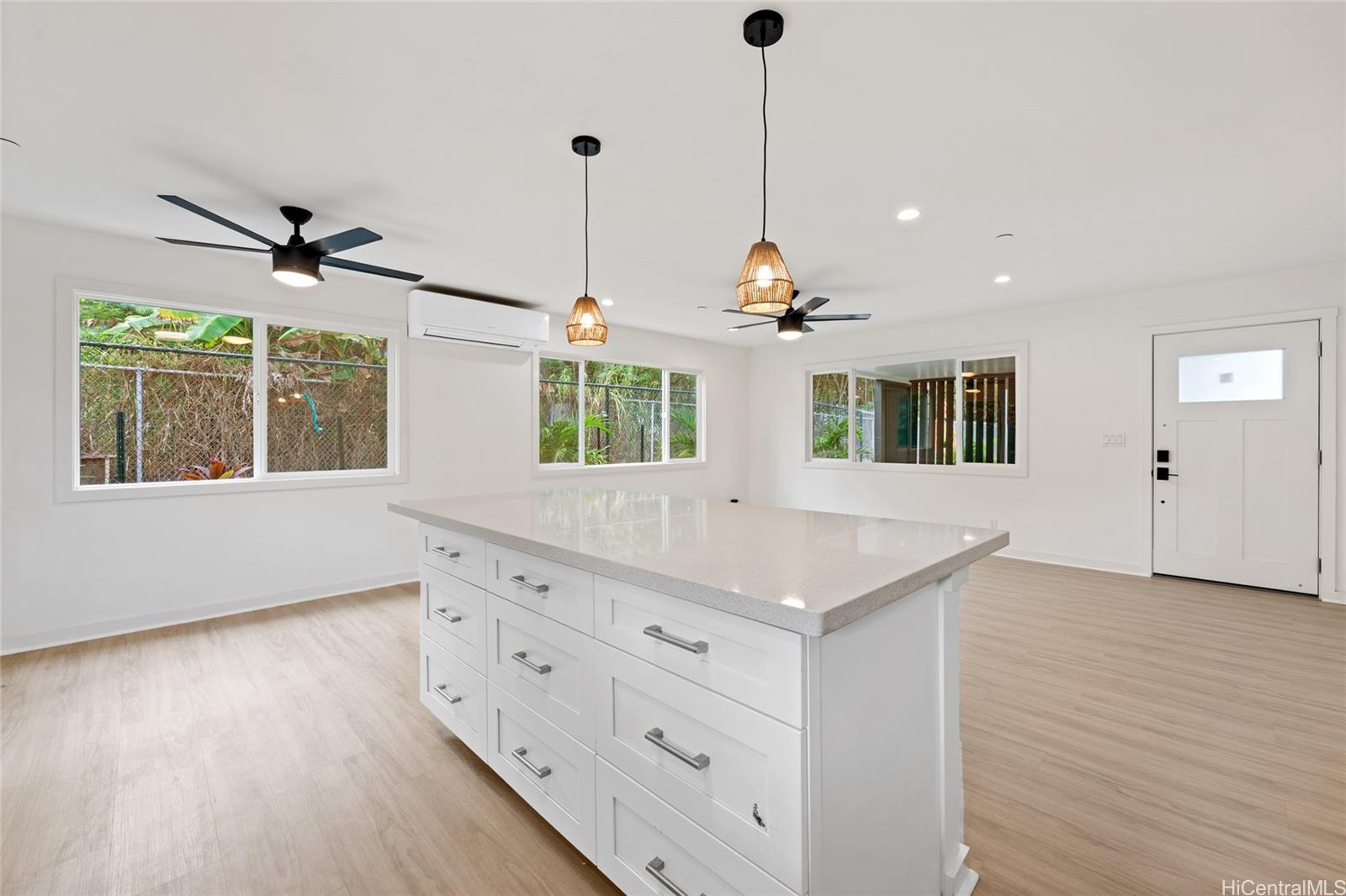 437 Kawailoa Road Kailua, HI 96734 - Photo 4 of 16 a view of an empty room with a window and wooden floor