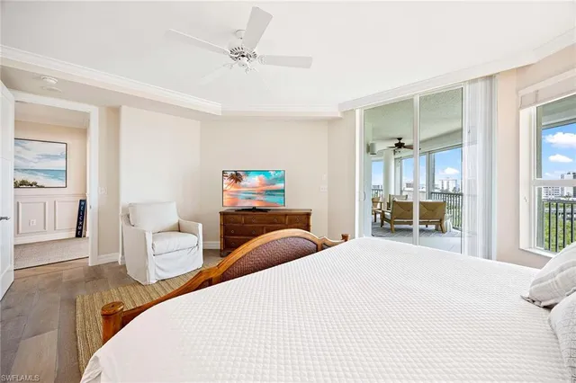 a bedroom with bed and a large window