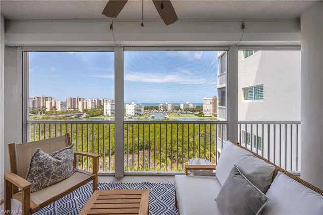a living room with furniture and a floor to ceiling window