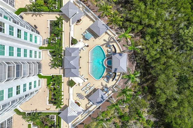 a view of a patio with swimming pool and sitting area