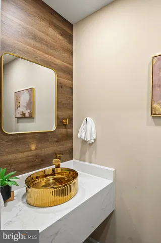 a living room with furniture a rug and a mirror