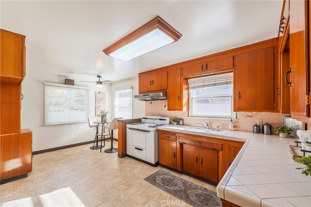 1241 South Walnut Street Anaheim, CA 92802 - Photo 12 of 36 a kitchen with a sink stove and cabinets