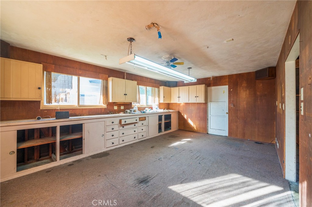 1241 South Walnut Street Anaheim, CA 92802 - Photo 29 of 36 a large white kitchen with stainless steel appliances granite countertop a stove and a sink