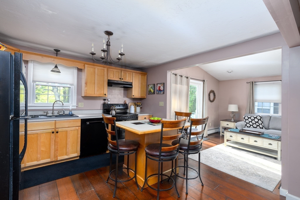 32 Westview Road Worcester, MA 01602 - Photo 4 of 18 a kitchen with stainless steel appliances granite countertop a stove a sink dishwasher a dining table and chairs with wooden floor