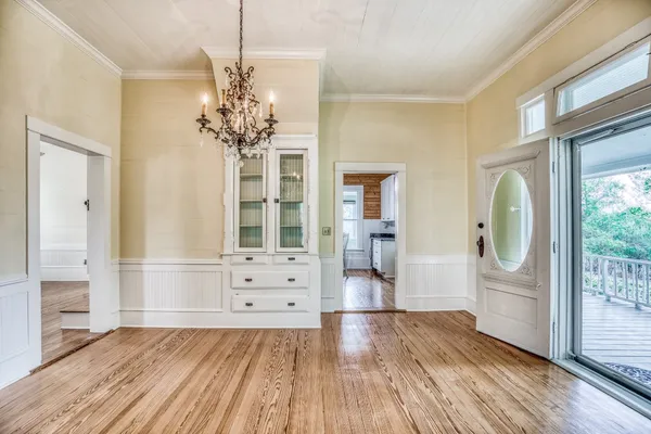 a kitchen with white cabinets and counter space