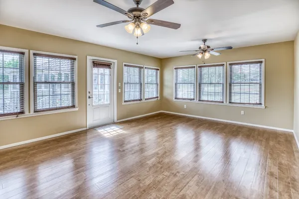 a view of a livingroom with a ceiling fan and wooden floor