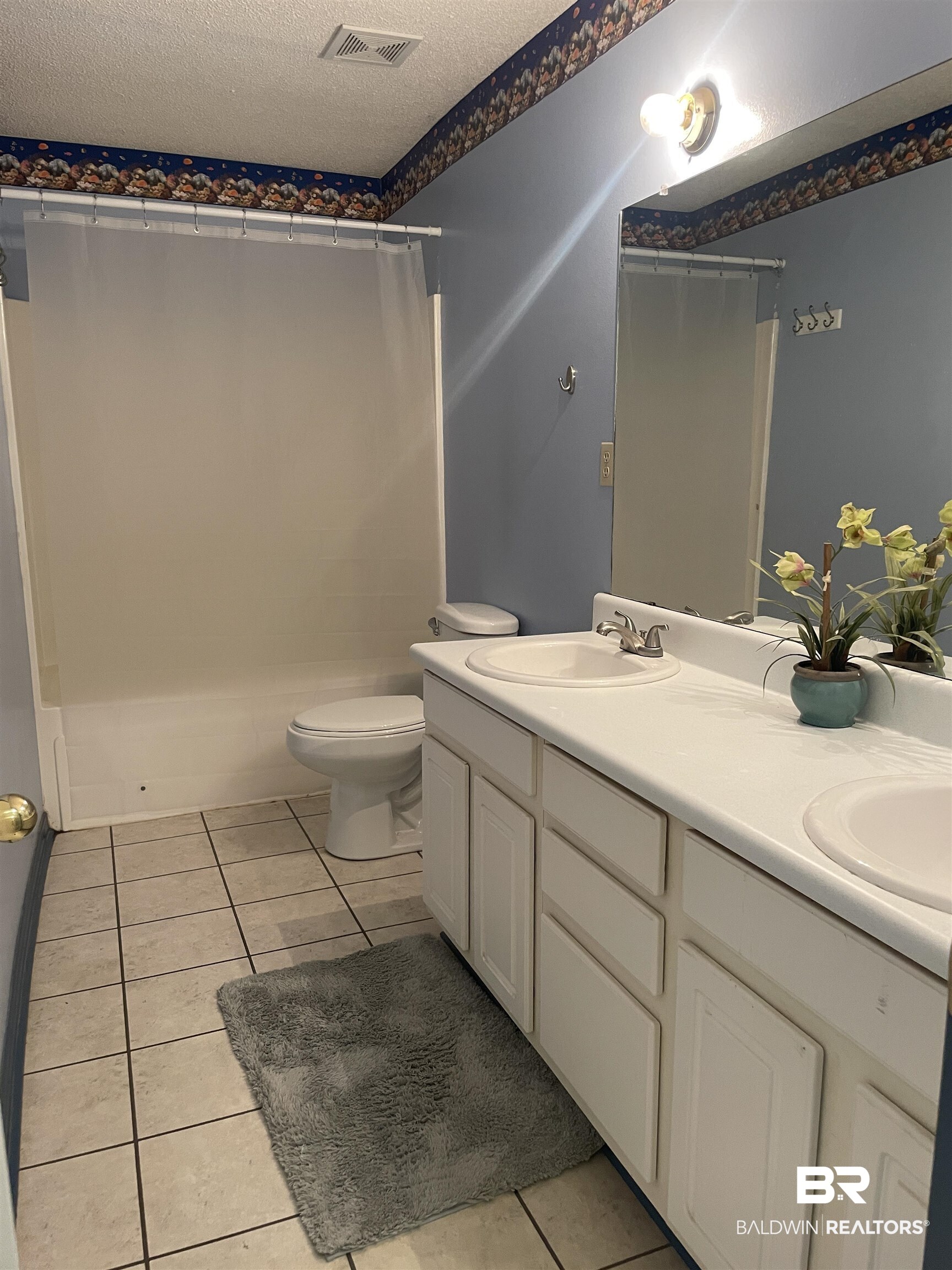 739 Smithfield Road Atmore, AL 36502 - Photo 10 of 18 Bathroom with tile patterned floors, a sink, a textured ceiling, and visible vents