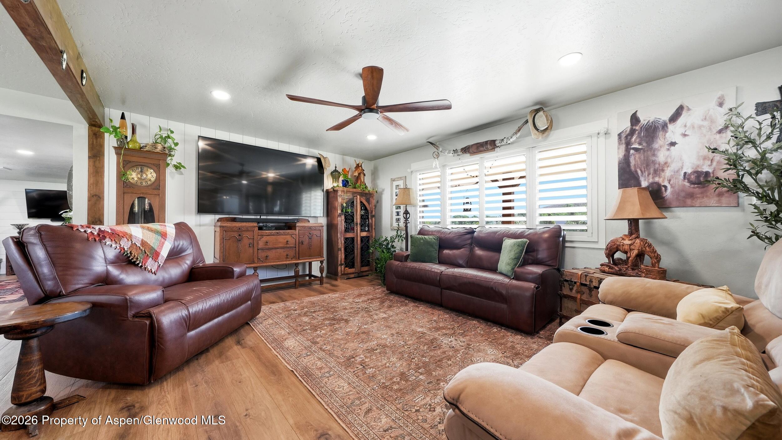 445 South Camp Road Grand Junction, CO 81507 - Photo 7 of 37 a living room with furniture and a flat screen tv