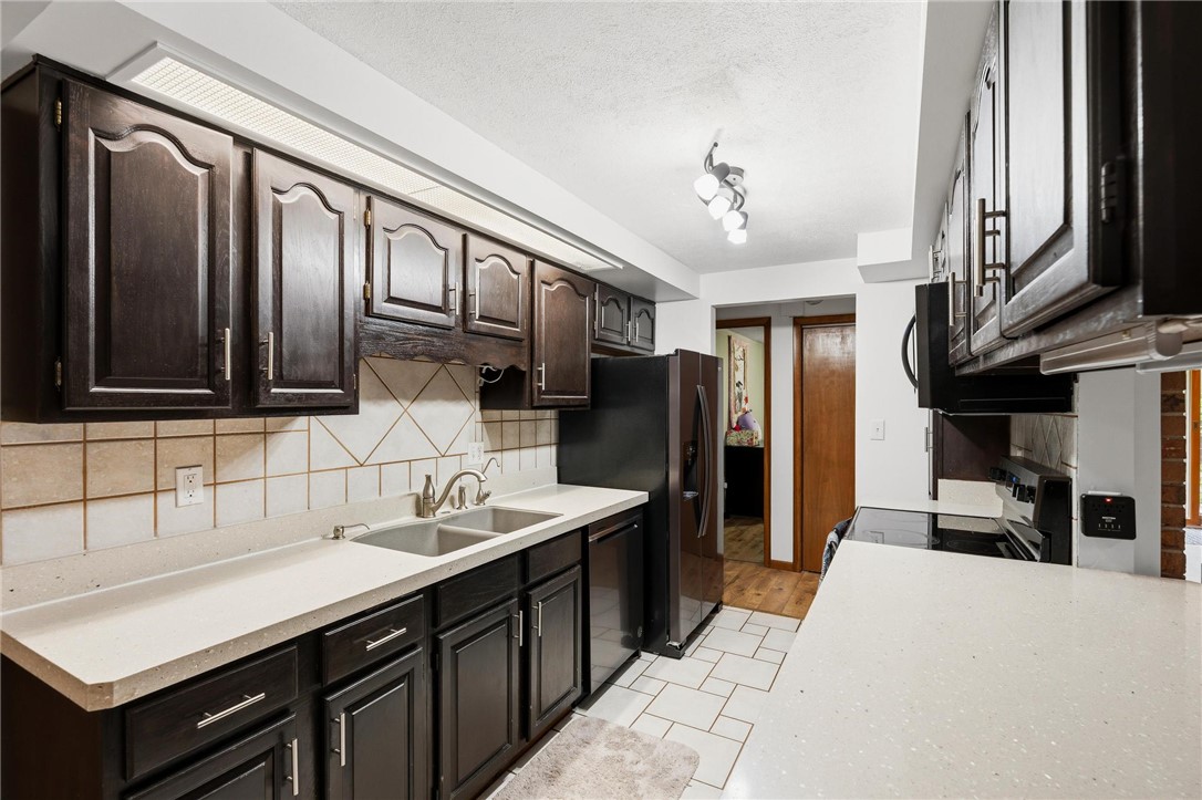 1940 Armstrong Road Fairborn, OH 45324 - Photo 24 of 48 This kitchen features sleek countertops and appliances, offering functionality and modern appeal.