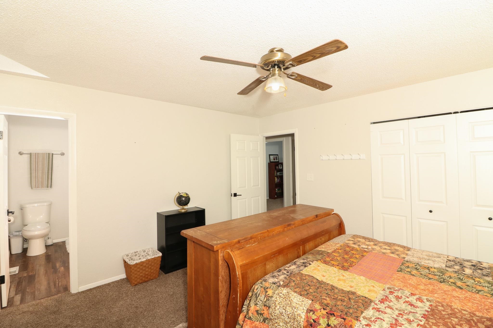 607-28 28 3/4 Road Grand Junction, CO 81506 - Photo 17 of 42 a bedroom with a bed and a chandelier