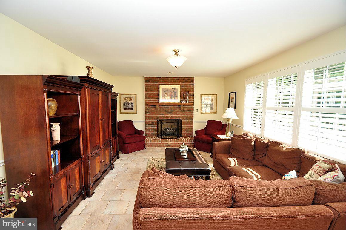 2906 Thornbrook Road Ellicott City, MD 21042 - Photo 14 of 30 Family Room w/ Stone Floor + Fireplace