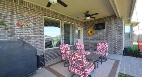 9111 Turnbull Lane Rosenberg, TX 77469 - Photo 26 of 29 a brick building with a bench and a potted plant