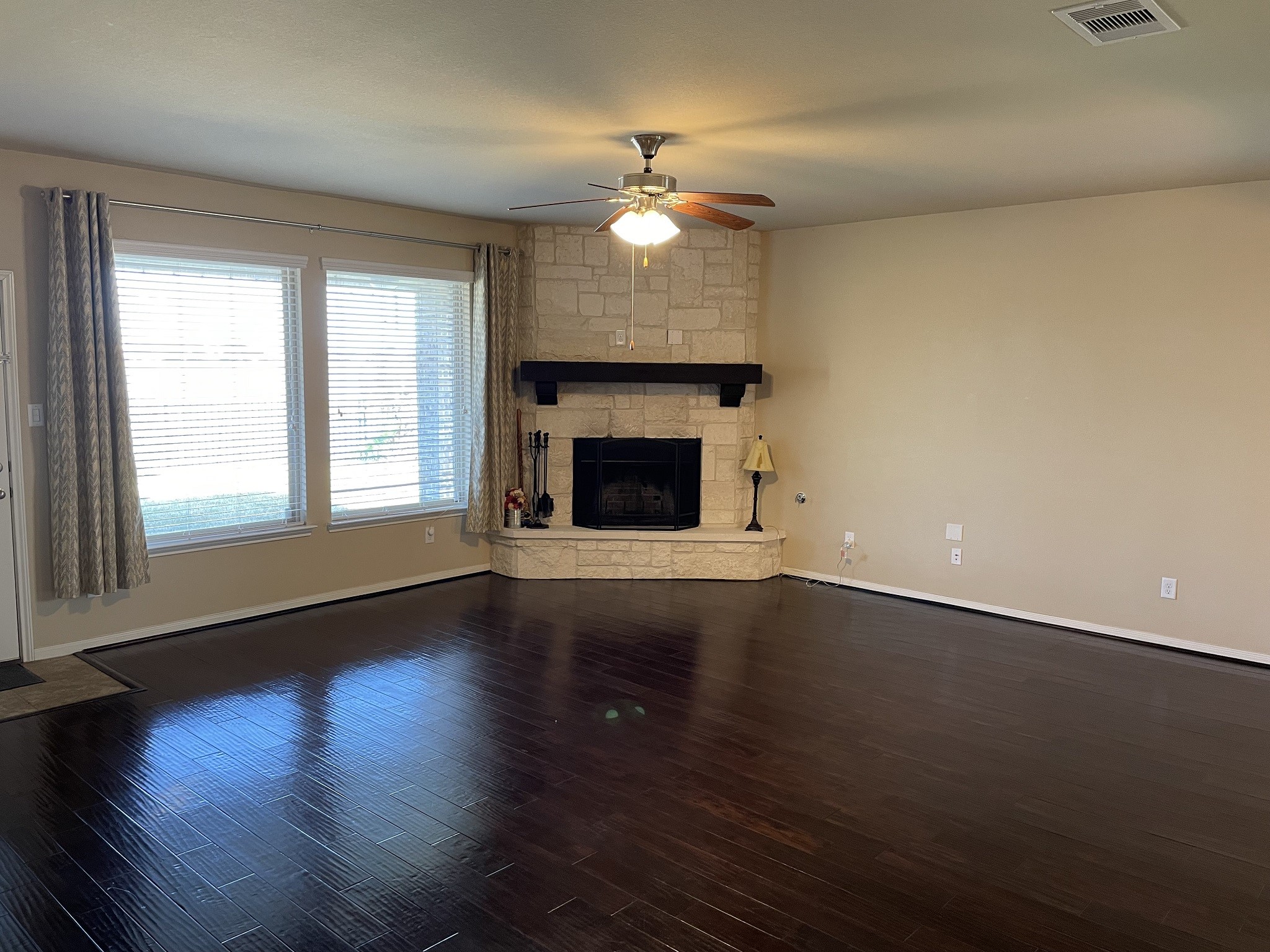 9111 Turnbull Lane Rosenberg, TX 77469 - Photo 4 of 29 an empty room with wooden floor fireplace and window