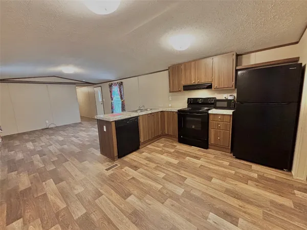 a kitchen with stainless steel appliances granite countertop a refrigerator and a stove