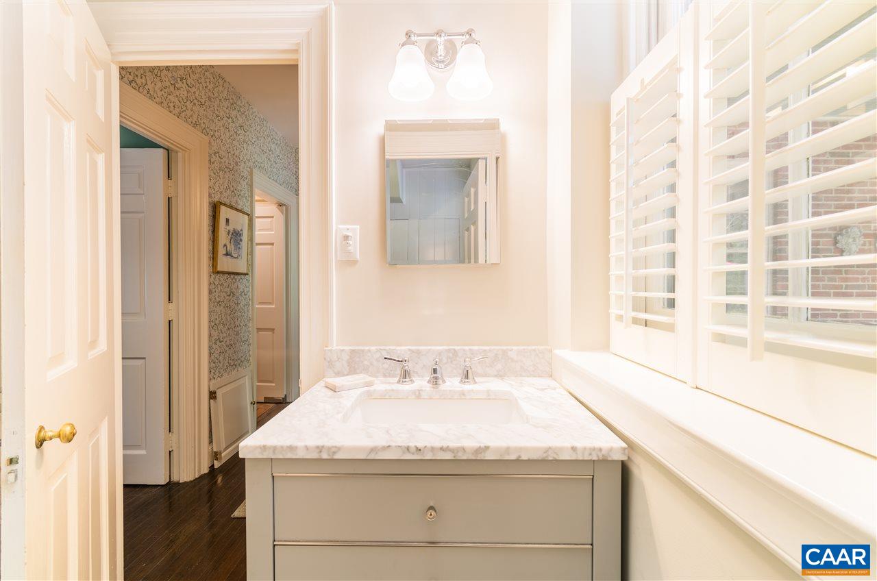 1931 Thomson Road Charlottesville, VA 22903 - Photo 18 of 42 a bathroom with a granite countertop sink and a mirror