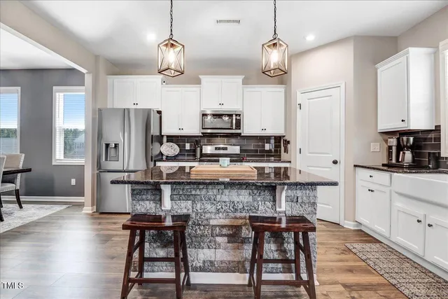 a kitchen with stainless steel appliances granite countertop a stove and a sink