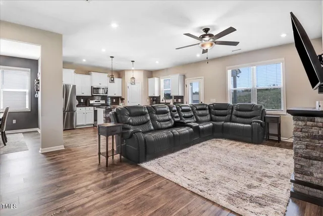 a living room with furniture a fireplace and a flat screen tv