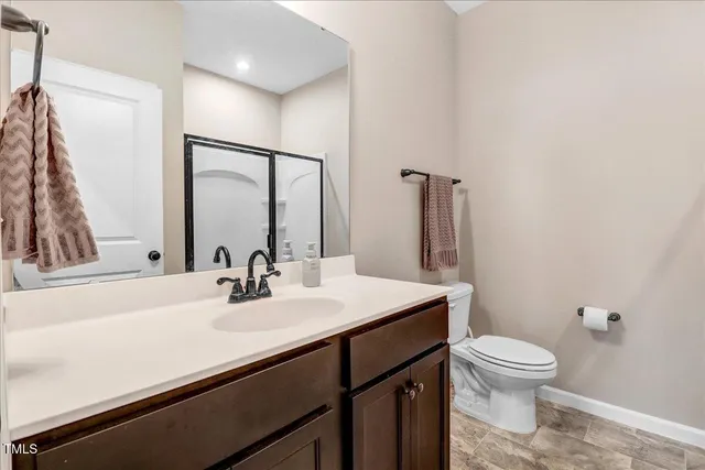 a bathroom with a glass shower door