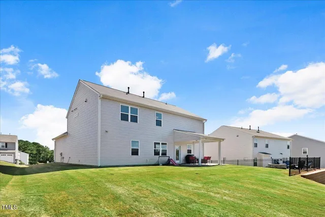 a view of a house with swimming pool and a yard