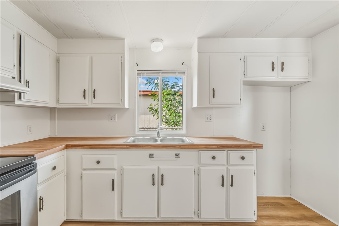 1267 Wilson Road Bullhead City, AZ 86442 - Photo 12 of 37 a kitchen with white cabinets and sink