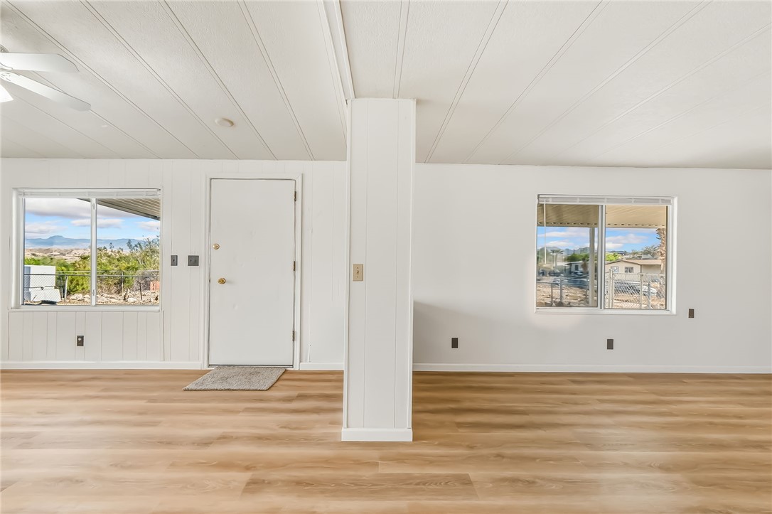 1267 Wilson Road Bullhead City, AZ 86442 - Photo 16 of 37 a view of an empty room with window and wooden floor