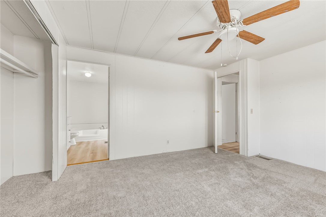 1267 Wilson Road Bullhead City, AZ 86442 - Photo 27 of 37 an empty room with fan and a ceiling fan