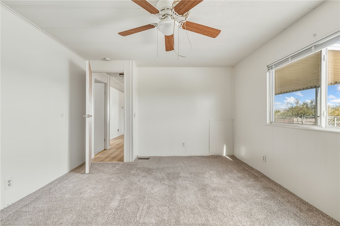 1267 Wilson Road Bullhead City, AZ 86442 - Photo 28 of 37 an empty room with a window and a fan