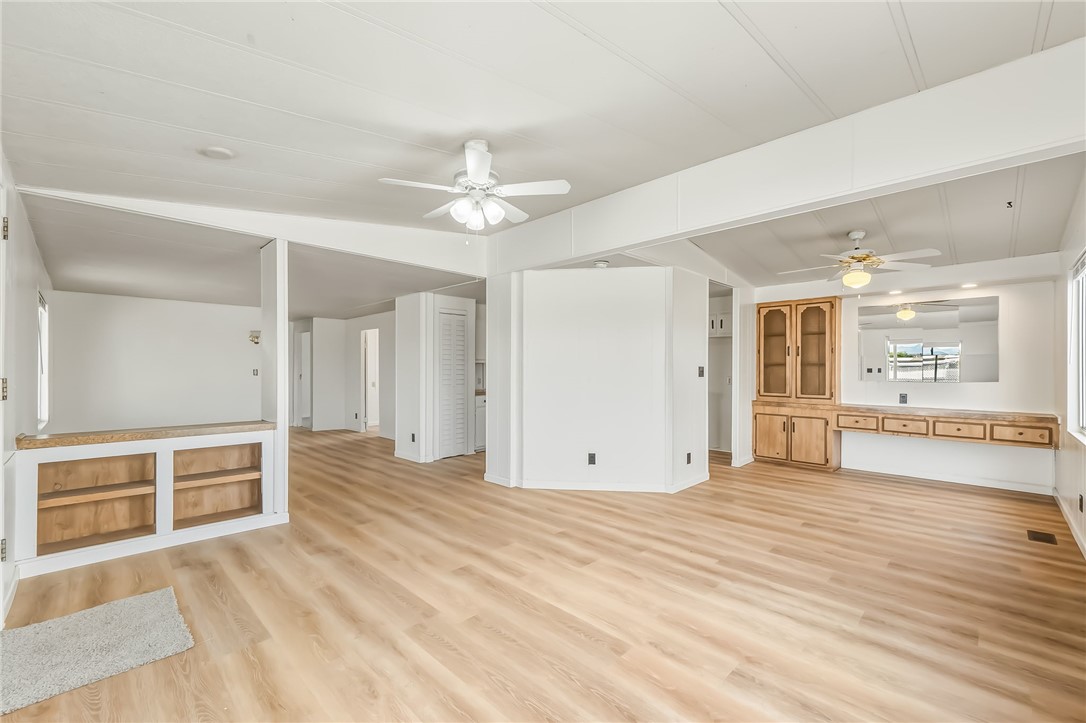 1267 Wilson Road Bullhead City, AZ 86442 - Photo 6 of 37 an empty room with wooden floor and windows