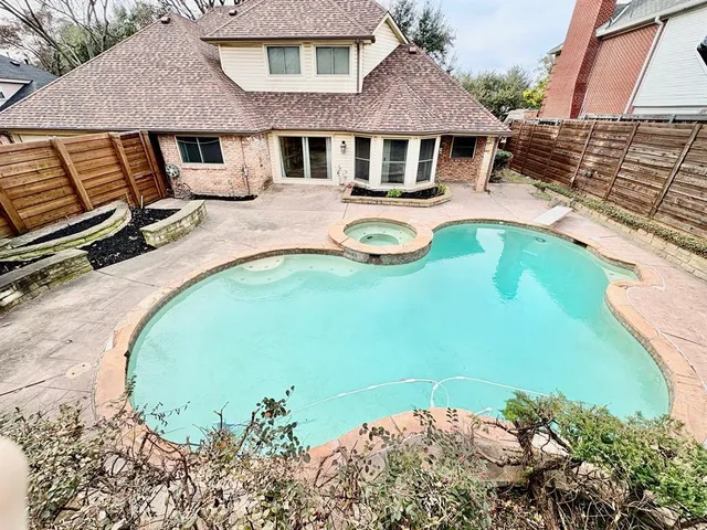 an aerial view of a house with swimming pool