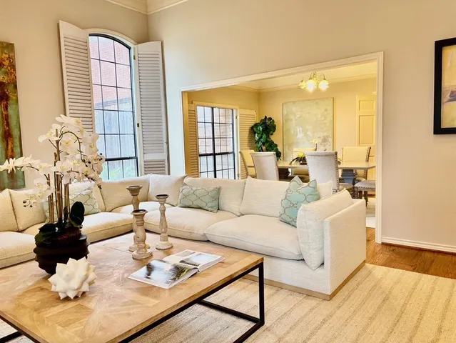 a living room with fireplace furniture and a large window