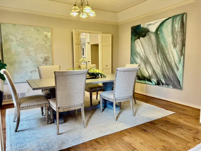 a dining room with furniture and wooden floor