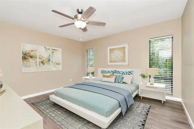 a bedroom with a large bed and a chandelier