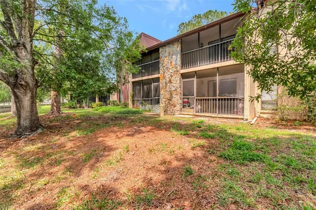 a house with large trees in front of it
