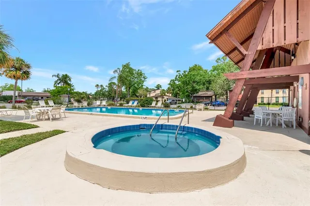 a view of a swimming pool with an outdoor seating and a yard