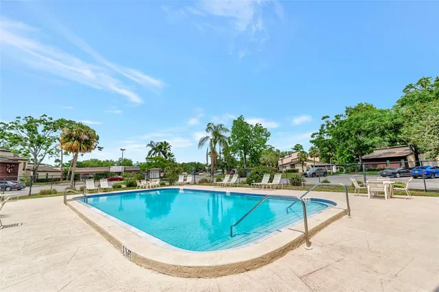 a view of a swimming pool with lounge chairs