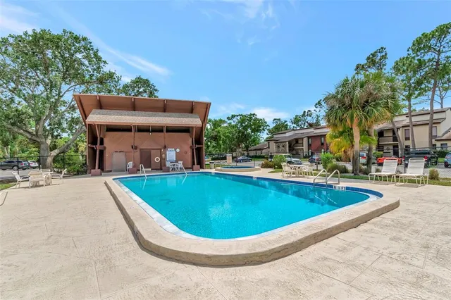 a view of a swimming pool with a patio