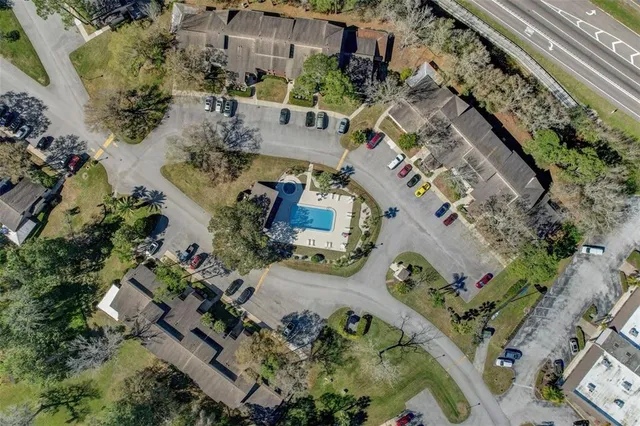 a view of house with backyard outdoor seating and tree