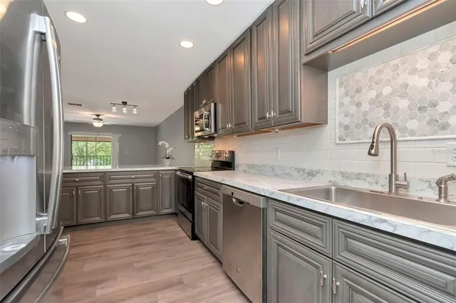 a kitchen with a sink cabinets and window