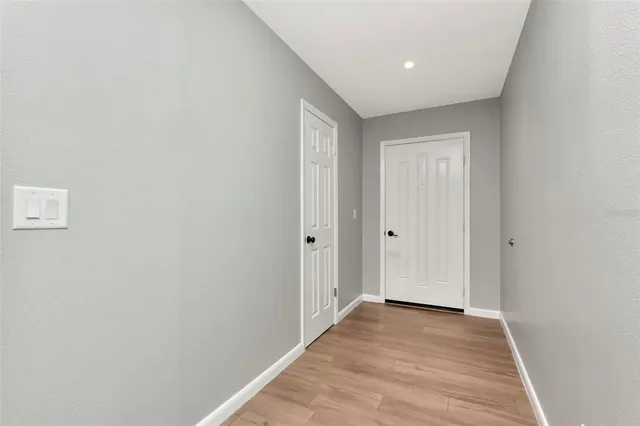 a view of a hallway with wooden floor
