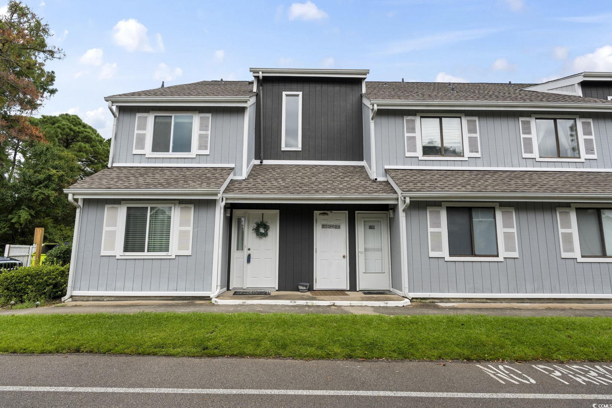 View of front of property featuring roof with shingles and covered porch