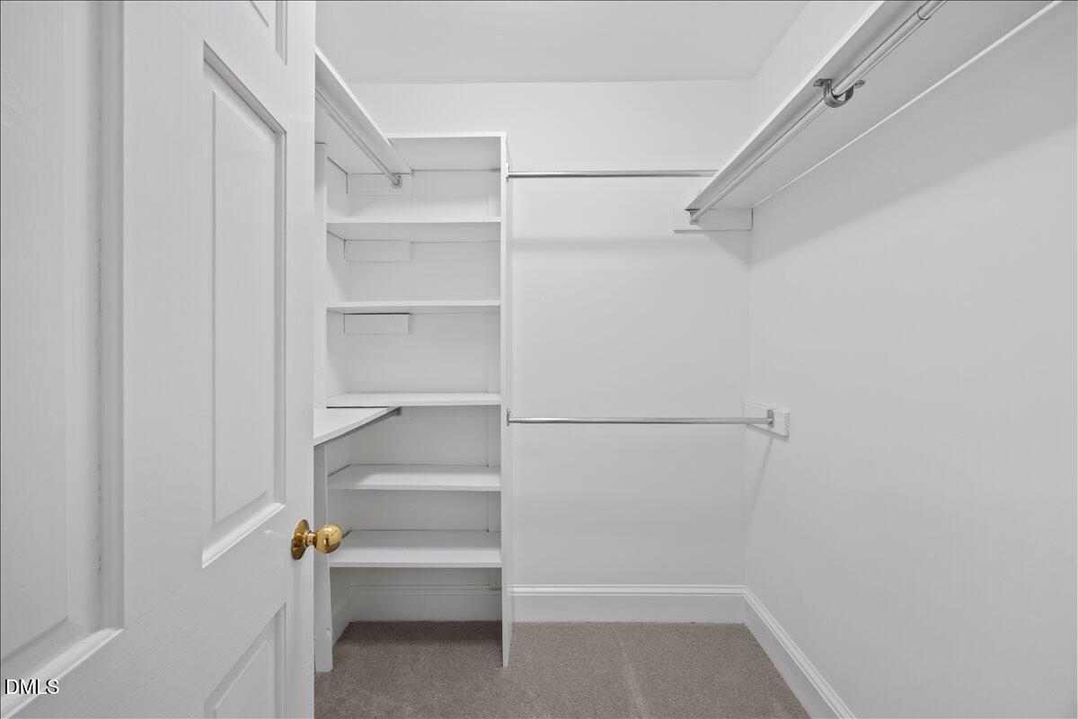 6516 Bakersfield Drive Raleigh, NC 27606 - Photo 36 of 59 a view of walk in closet with empty racks