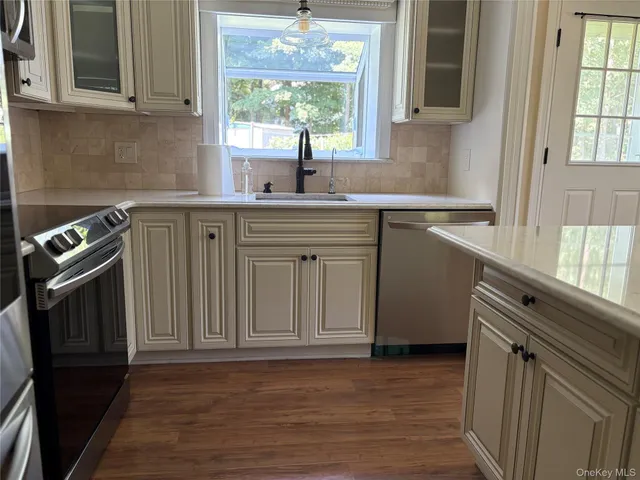 a kitchen with a sink stove and cabinets
